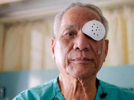 Patient wearing an eye shield after surgery